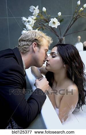 Stock Photo - Couple kissing in bubble bath. Fotosearch