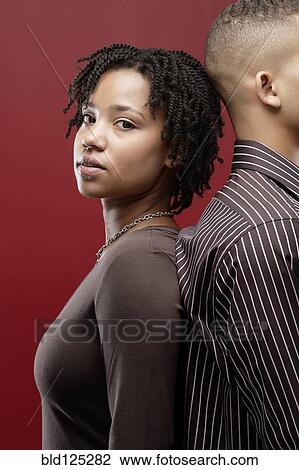 Couple standing back to back View Large Photo Image Stock Image - Couple standing back to back. Fotosearch
