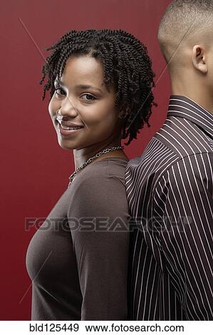 Couple standing back to back View Large Photo Image Stock Photo - Couple standing back to back. Fotosearch