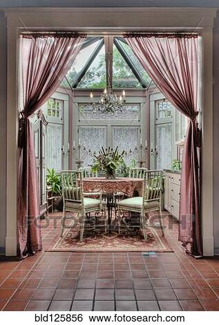 Stock Photograph - Curtains and dining table in ornate dining room. Fotosearch
