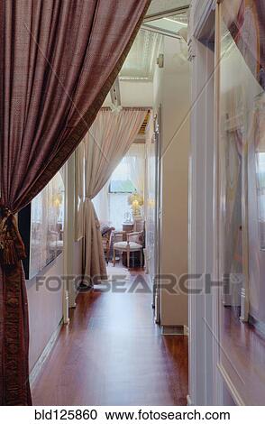 Stock Image - Curtains in corridor of house. Fotosearch