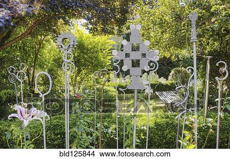 Picture - Decorations in lush garden. Fotosearch