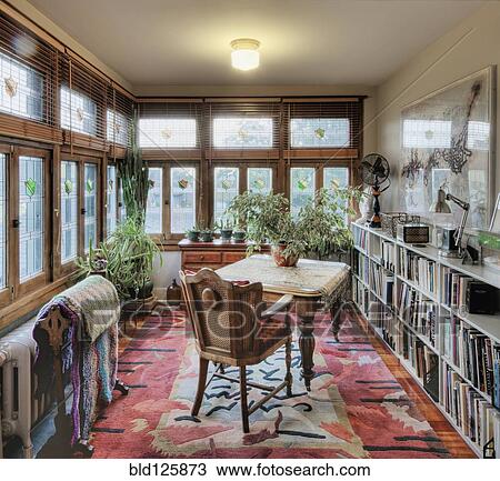 Stock Image - Desk and chair in den. Fotosearch