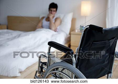 Disabled Caucasian man in bed out of reach of wheelchair View Large Photo Image Stock Image - Disabled Caucasian man in bed out of reach of wheelchair. Fotosearch