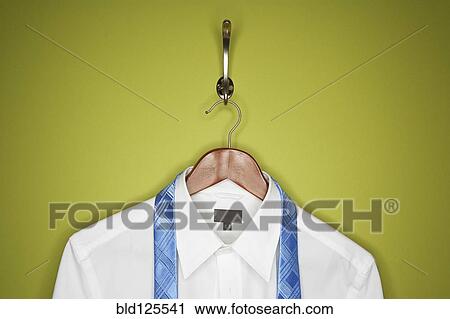 Stock Image - Dress shirt and tie on hanger. Fotosearch