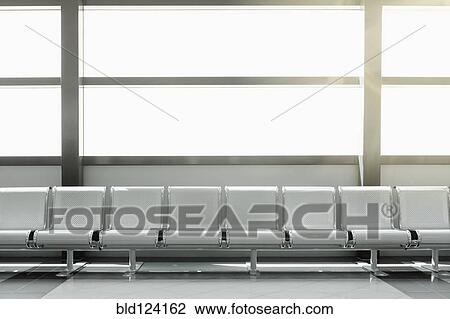 Stock Image - Empty seats in airport lobby. Fotosearch