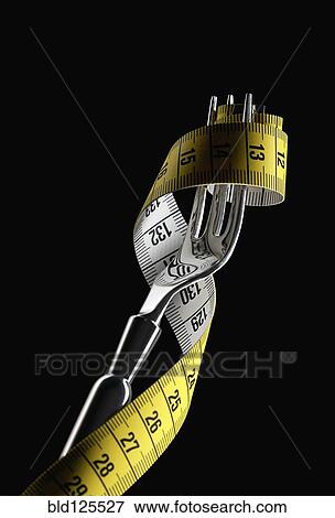 Fork holding tape measure View Large Photo Image Stock Photo - Fork holding tape measure. Fotosearch