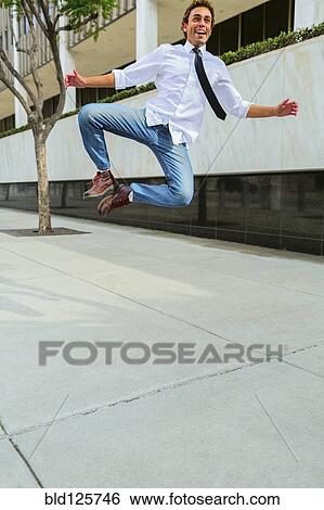 Stock Photograph - Hispanic businessman clicking his heels. Fotosearch