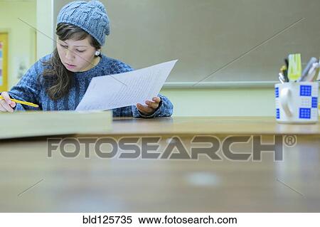 Stock Photography - Hispanic student working in classroom. Fotosearch