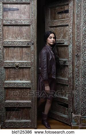 Hispanic woman standing in ornate doorway View Large Photo Image Stock Photograph - Hispanic woman standing in ornate doorway. Fotosearch