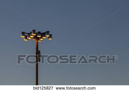 Stock Photo - Holophane streetlights against blue sky. Fotosearch