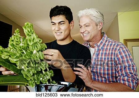 Homosexual couple arranging flowers View Large Photo Image Stock Image - Homosexual couple arranging flowers. Fotosearch