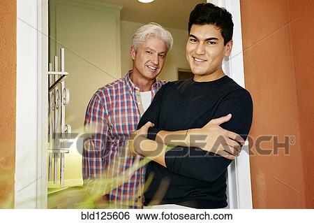 Homosexual couple smiling in doorway View Large Photo Image Stock Photograph - Homosexual couple smiling in doorway. Fotosearch