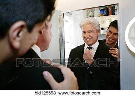 Stock Photo - Homosexual couple smiling in mirror. Fotosearch