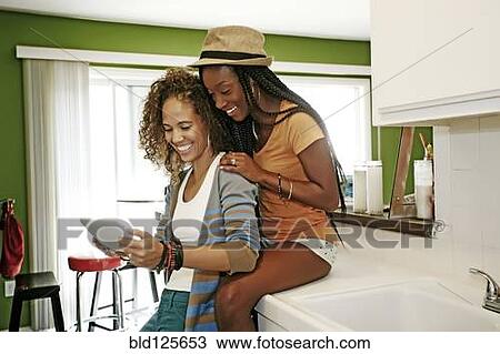 Homosexual couple using digital tablet in kitchen View Large Photo Image Stock Image - Homosexual couple using digital tablet in kitchen. Fotosearch