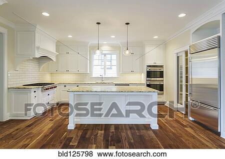 Stock Photo - Island and counters in luxury kitchen. Fotosearch