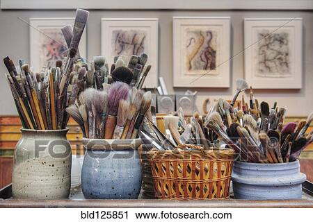 Jars of paintbrushes on desk View Large Photo Image Stock Image - Jars of paintbrushes on desk. Fotosearch