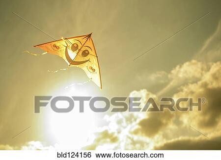 Kite flying in sunny sky View Large Photo Image Stock Photograph - Kite flying in sunny sky. Fotosearch