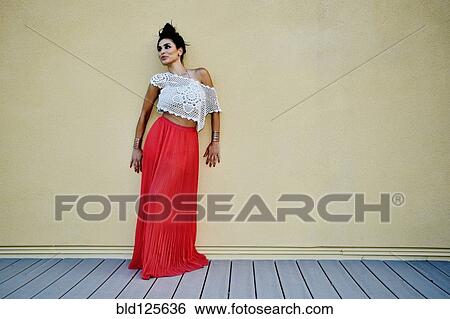Middle Eastern woman leaning against wall outdoors View Large Photo Image Stock Photograph - Middle Eastern woman leaning against wall outdoors. Fotosearch