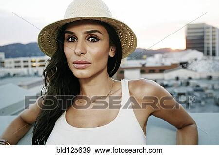 Stock Photo - Middle Eastern woman on urban rooftop. Fotosearch