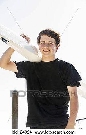 Mixed race boy carrying scull outdoors View Large Photo Image Picture - Mixed race boy carrying scull outdoors. Fotosearch