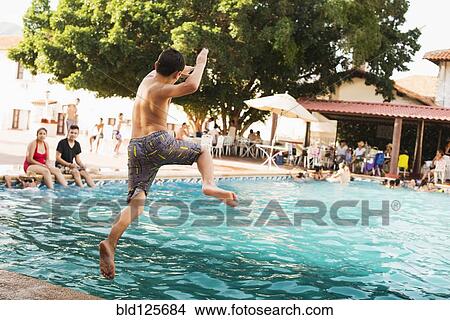 Mixed race boy jumping into pool View Large Photo Image Picture - Mixed race boy jumping into pool. Fotosearch