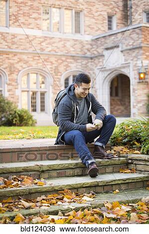 Mixed race college student sitting on campus steps View Large Photo Image Stock Photo - Mixed race college student sitting on campus steps. Fotosearch
