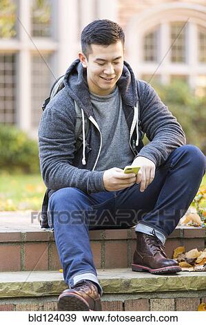 Mixed race college student sitting on campus steps View Large Photo Image Stock Photo - Mixed race college student sitting on campus steps. Fotosearch