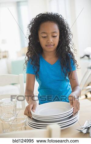 Mixed race girl setting table View Large Photo Image Stock Photography - Mixed race girl setting table. Fotosearch