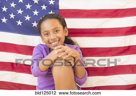 Mixed race girl smiling by American flag View Large Photo Image Stock Image - Mixed race girl smiling by American flag. Fotosearch