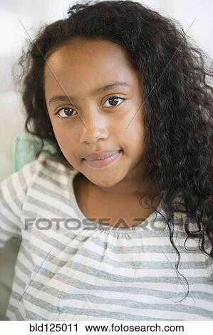 Stock Image - Mixed race girl smiling. Fotosearch