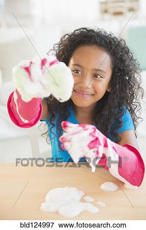 Mixed race girl washing dishes View Large Photo Image Stock Photo - Mixed race girl washing dishes. Fotosearch