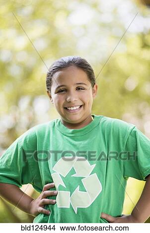 Picture - Mixed race girl wearing recycling t-shirt outdoors. Fotosearch