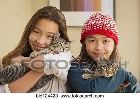 Mixed race girls holding kittens View Large Photo Image Stock Image - Mixed race girls holding kittens. Fotosearch