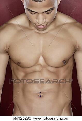 Mixed race man flexing abdominal muscles View Large Photo Image Stock Photograph - Mixed race man flexing abdominal muscles. Fotosearch