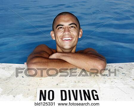 Mixed race man smiling at edge of swimming pool View Large Photo Image Stock Image - Mixed race man smiling at edge of swimming pool. Fotosearch