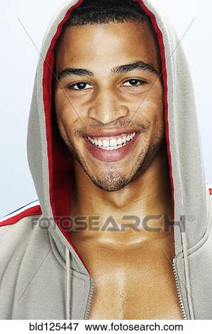 Stock Photo - Mixed race man smiling in hoody. Fotosearch