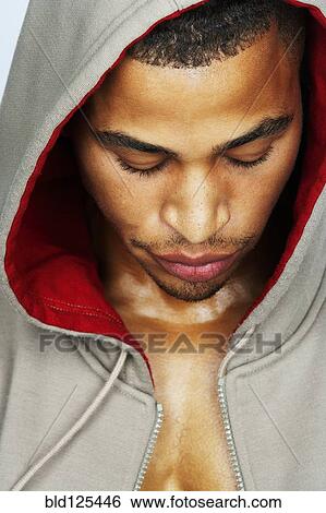 Stock Photograph - Mixed race man wearing hoody. Fotosearch