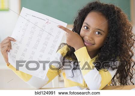 Mixed race student showing off A plus grade in classroom View Large Photo Image Stock Image - Mixed race student showing off A plus grade in classroom. Fotosearch