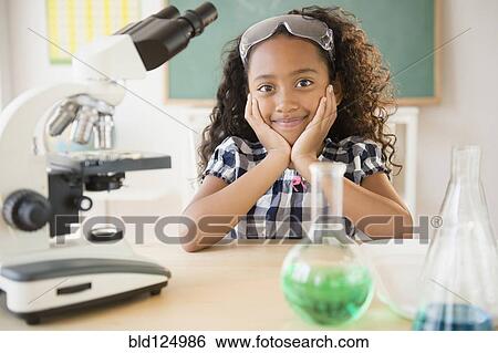 Stock Photograph - Mixed race student smiling in chemistry lab. Fotosearch