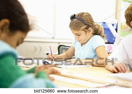 Mixed race student working in class View Large Photo Image Stock Image - Mixed race student working in class. Fotosearch