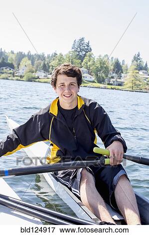 Mixed race teenage boy rowing scull on lake View Large Photo Image Stock Photo - Mixed race teenage boy rowing scull on lake. Fotosearch
