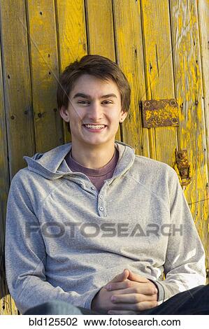 Stock Image - Mixed race teenage boy smiling. Fotosearch