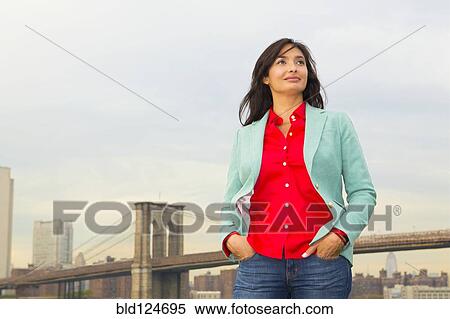 Stock Photography - Mixed race woman and city skyline, New York, New York, United States. Fotosearch