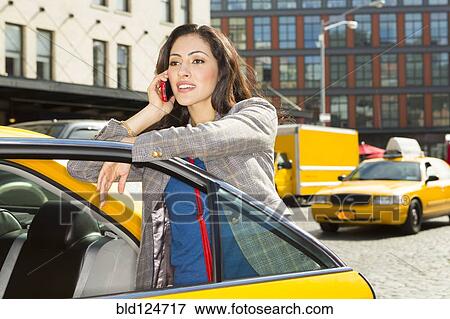 Stock Photo - Mixed race woman getting into taxi. Fotosearch