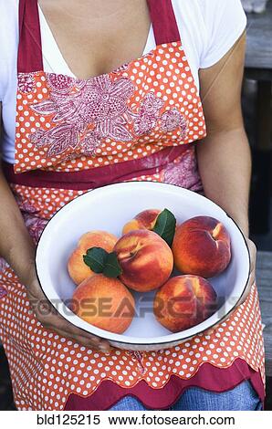 Mixed race woman holding bowl of peaches View Large Photo Image Stock Photography - Mixed race woman holding bowl of peaches. Fotosearch