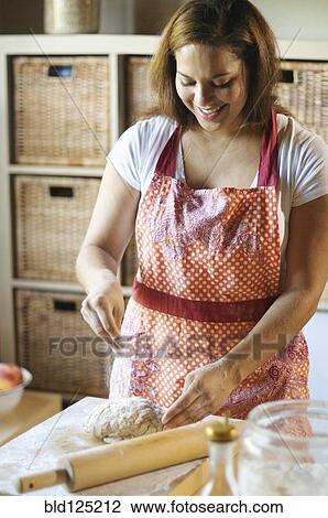 Mixed race woman kneading dough in kitchen View Large Photo Image Stock Image - Mixed race woman kneading dough in kitchen. Fotosearch