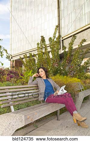 Mixed race woman sitting on park bench View Large Photo Image Stock Photography - Mixed race woman sitting on park bench. Fotosearch