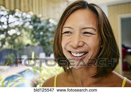 Stock Photo - Mixed race woman smiling. Fotosearch