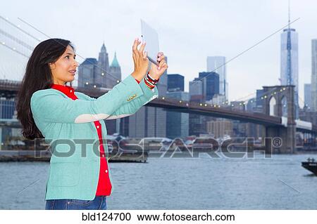 Mixed race woman taking pictures at waterfront, New York, New York, United States View Large Photo Image Stock Image - Mixed race woman taking pictures at waterfront, New York, New York, United States. Fotosearch